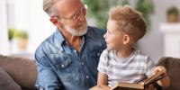 grandfather reading to grandson